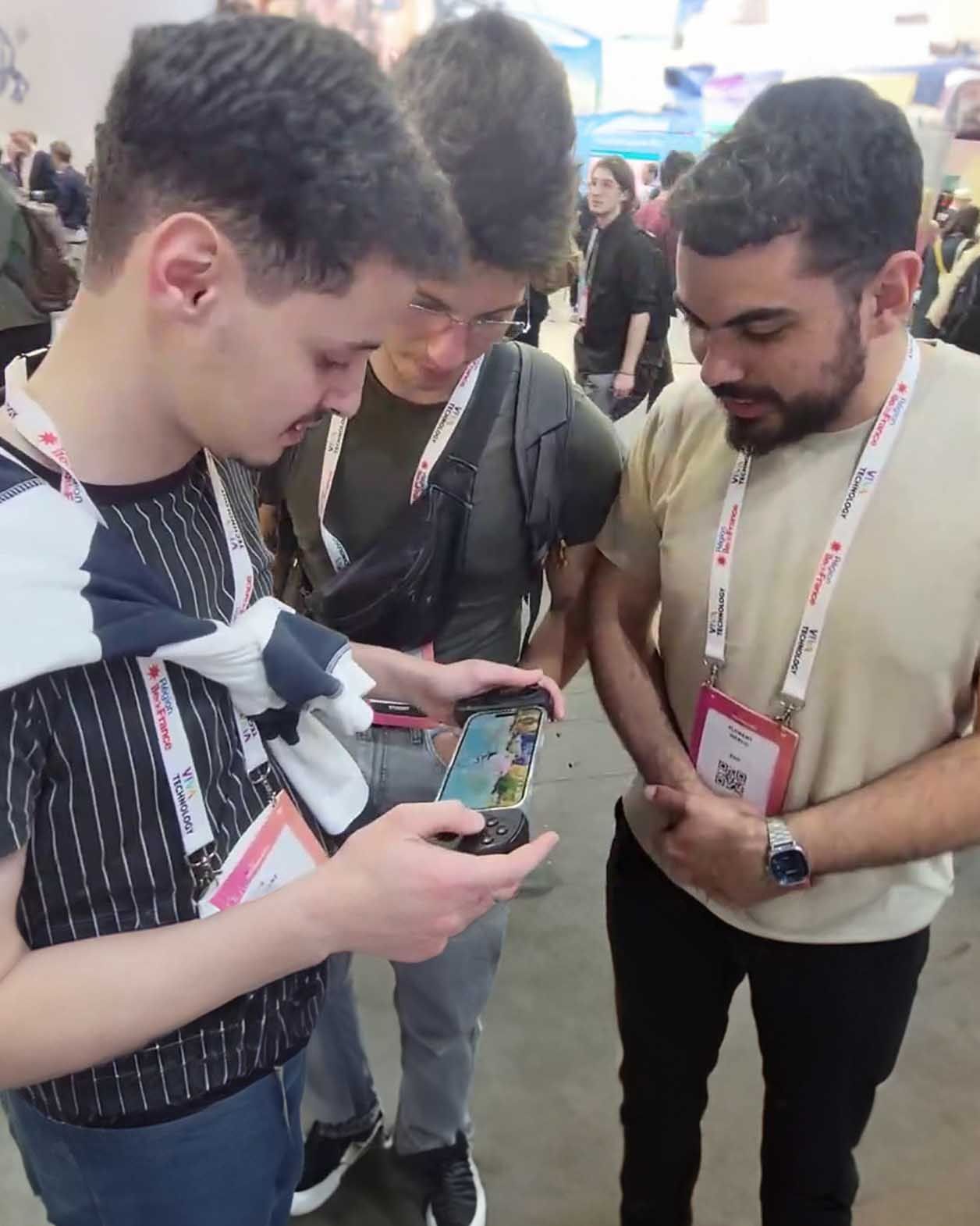 Three men play Genshin Impact with the Serafim S3 at the booth in VivaTech 2024